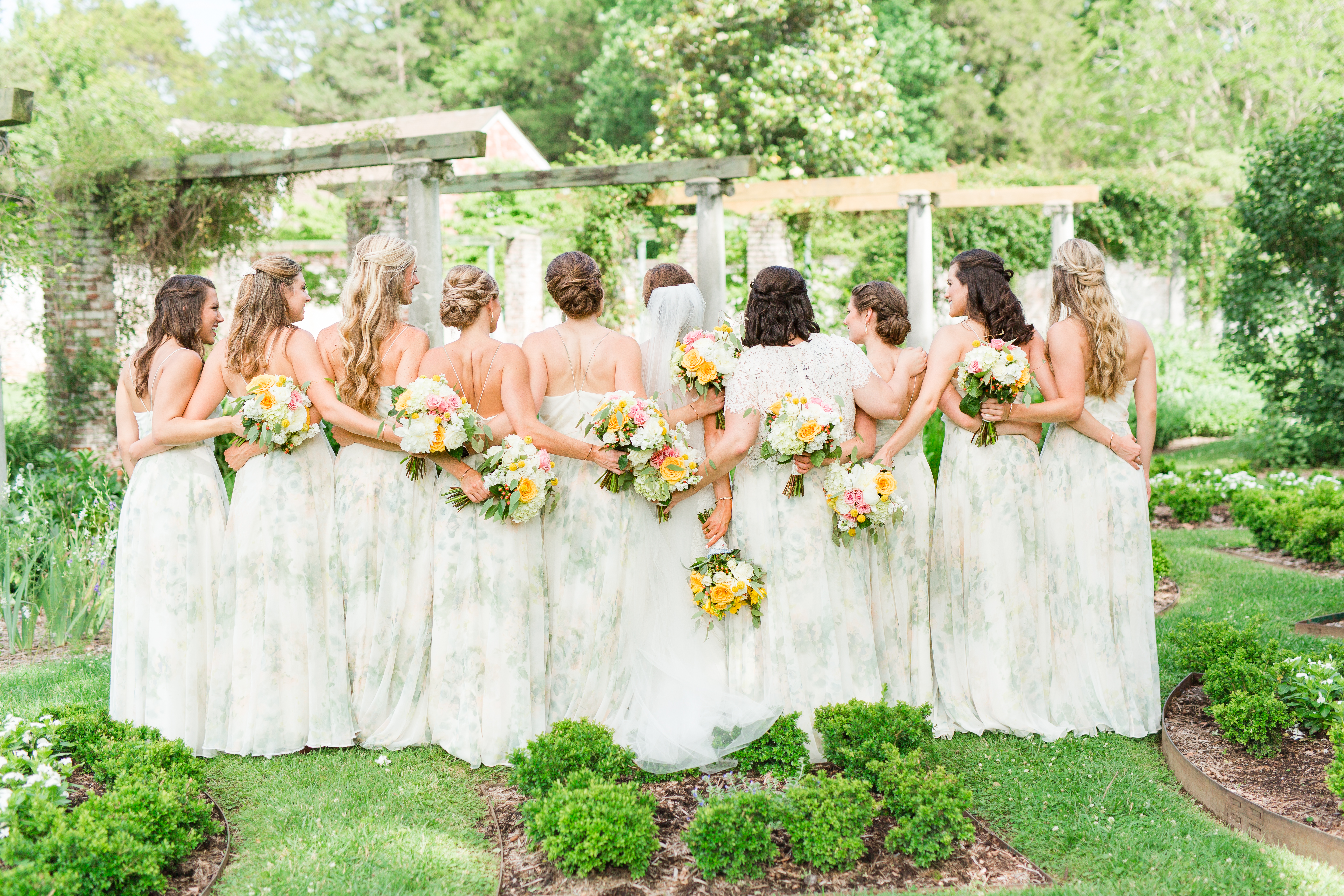 Bridal Pictures at Chatham Manor with bridesmaids and yellow flowers. Bridesmaids in white floral dresses. 