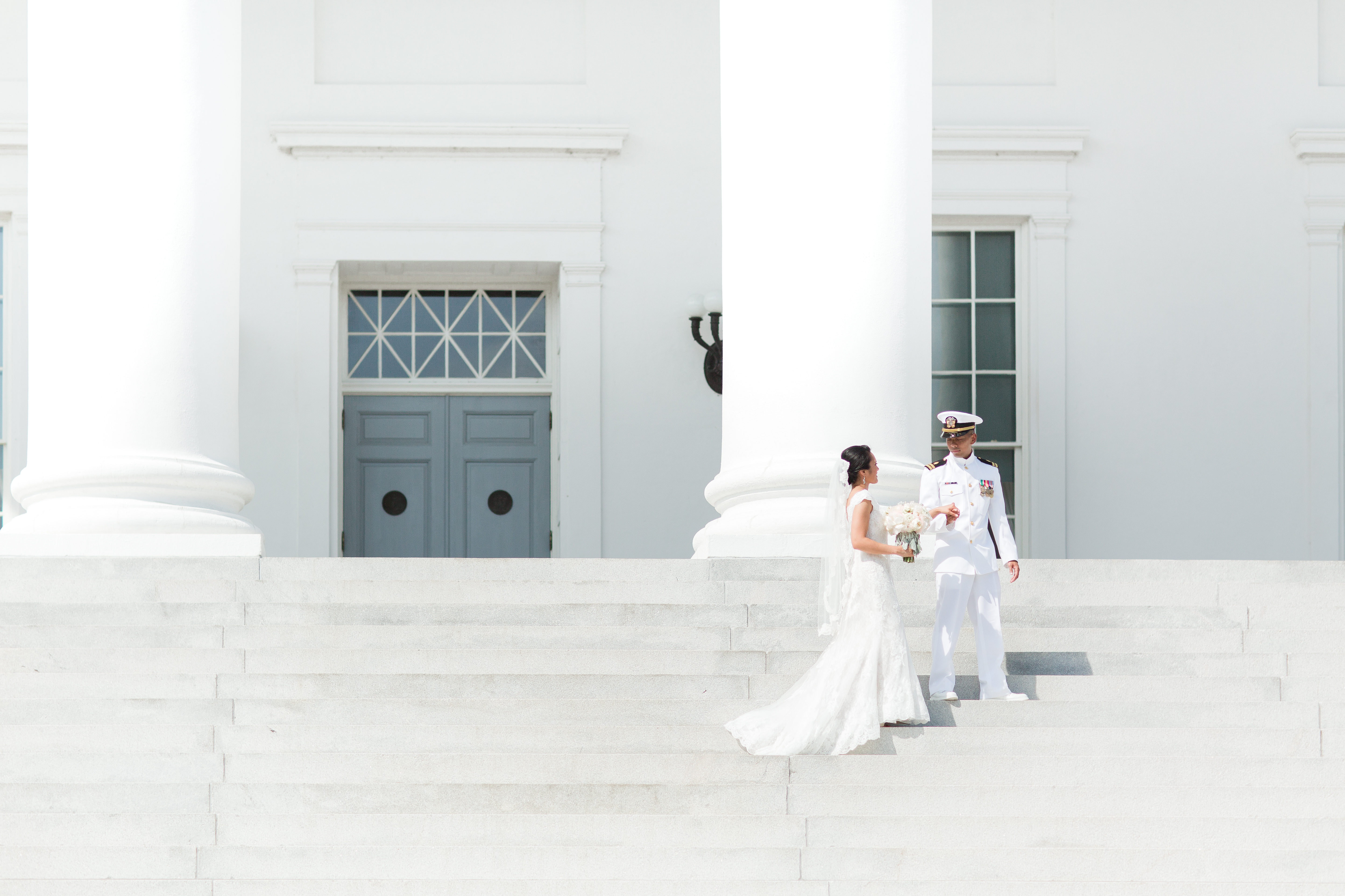 Bride and groom walking along stairs of virginia capital building