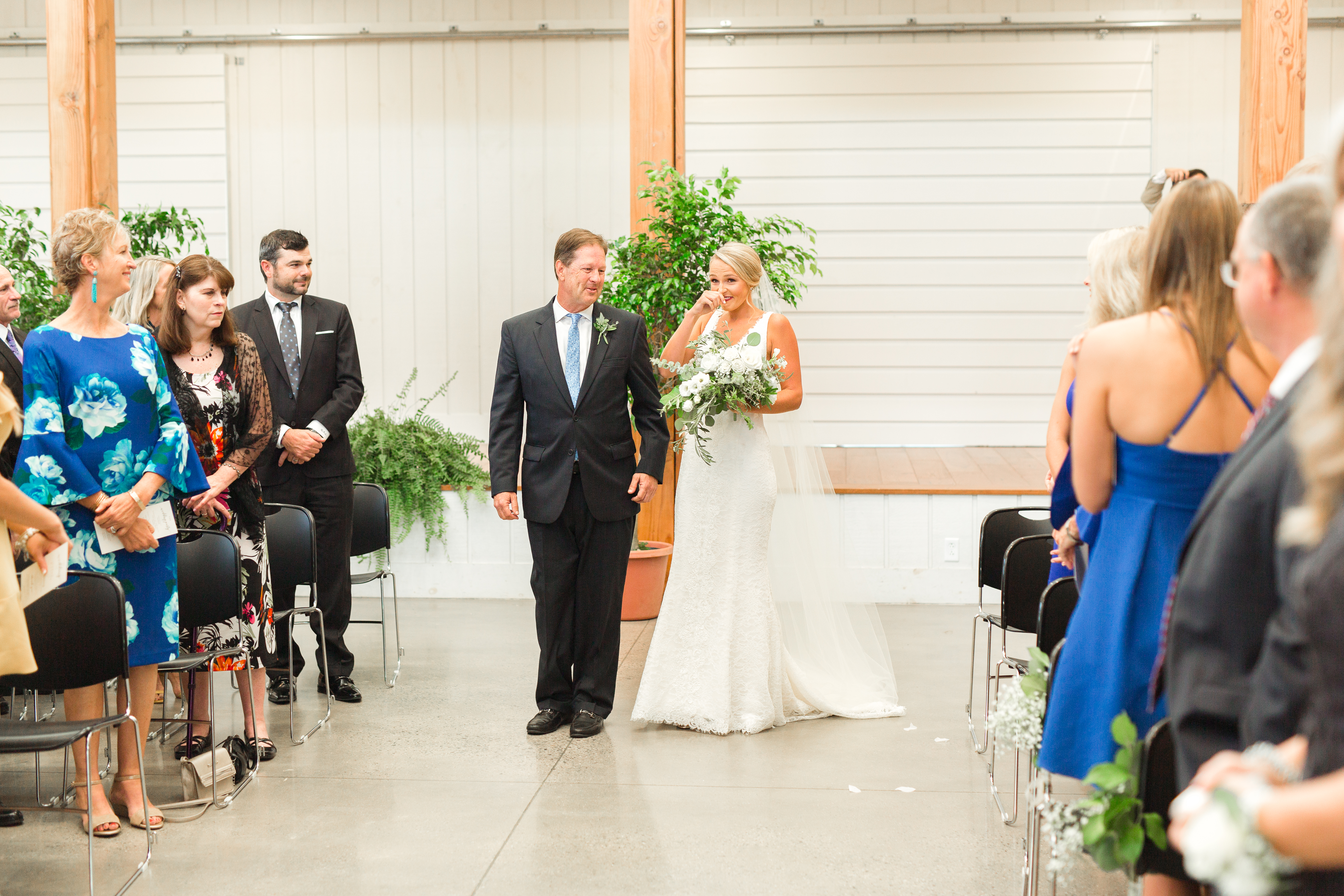 bride walking down aisle with dad crying