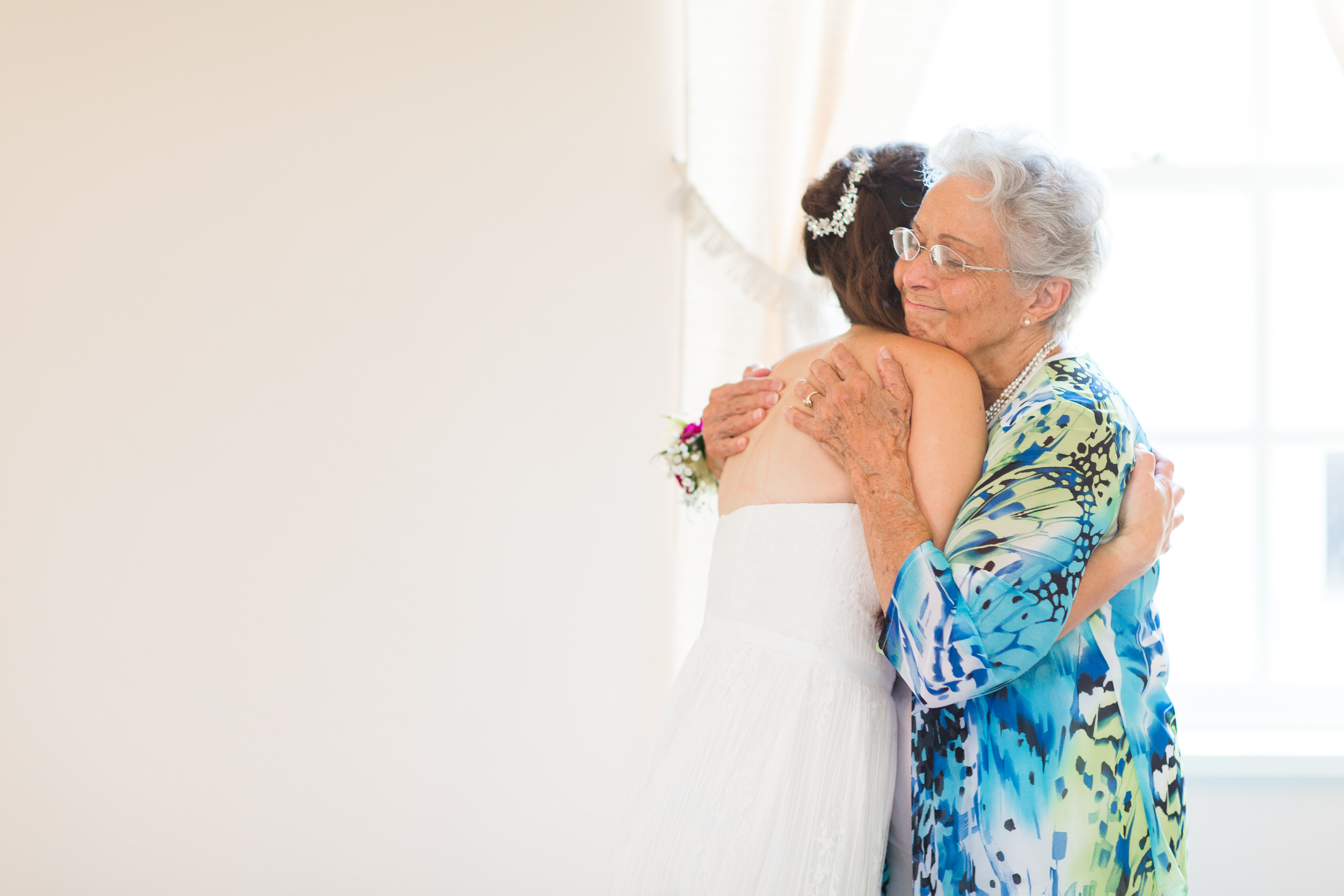 Grandma hugging her granddaughter on her wedding day